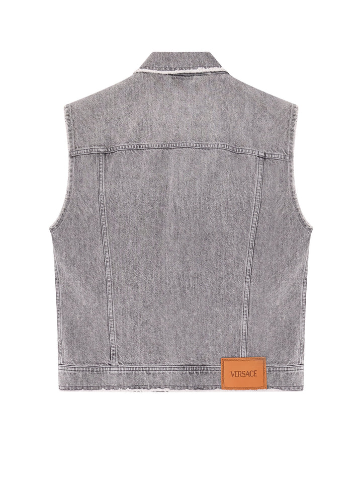 Denim sleeveless jacket with ripped profiles