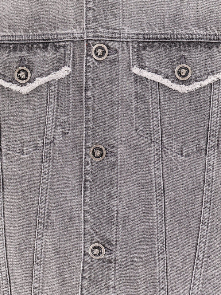 Denim sleeveless jacket with ripped profiles