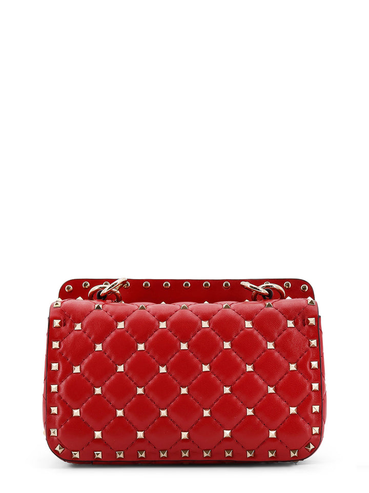 Quilted leather shoulder bag with iconic studs