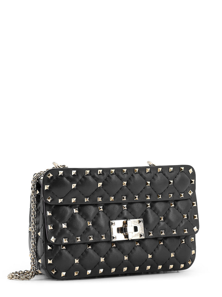 Leather shoulder bag with iconic metal studs