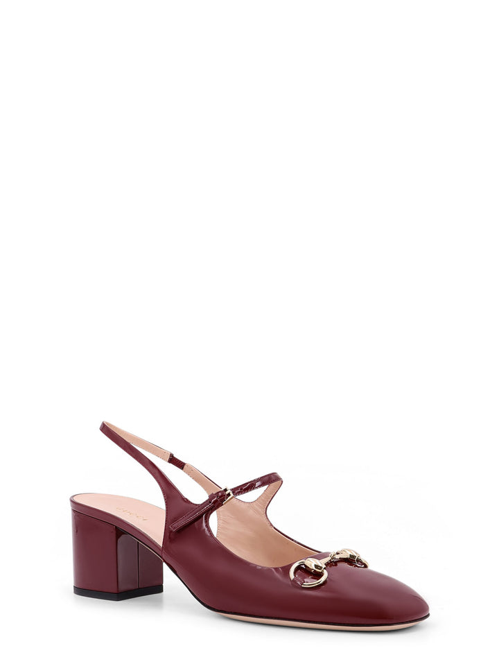 Patent leather décolleté with Iconic metal Horsebit, double strap and covered heel