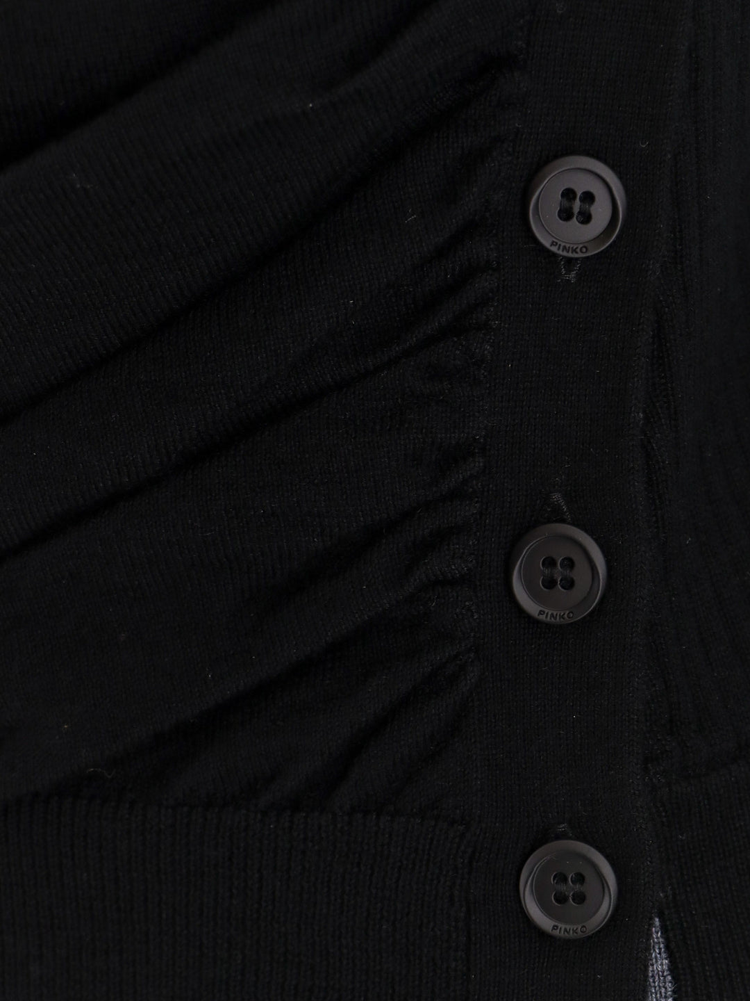 Wool sweater with lateral buttons