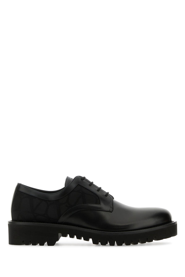 Black leather and Tolie Iconographe lace-up shoes