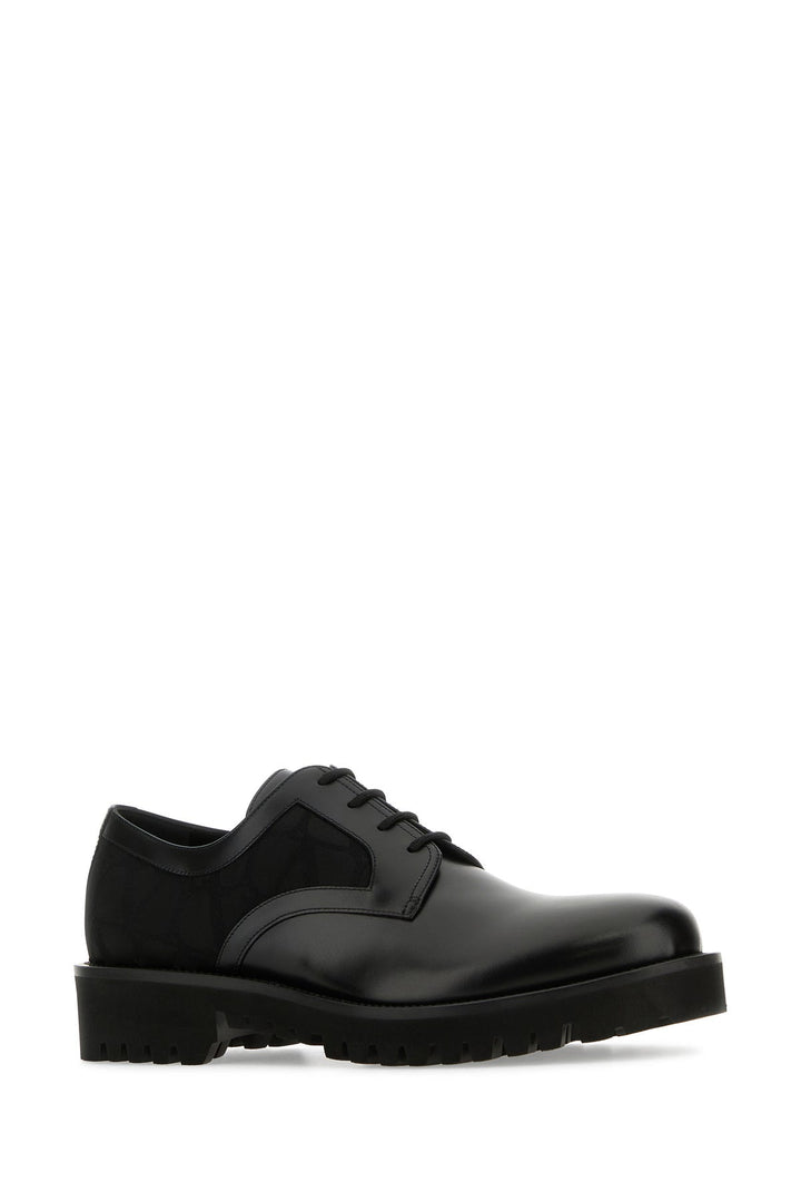 Black leather and Tolie Iconographe lace-up shoes