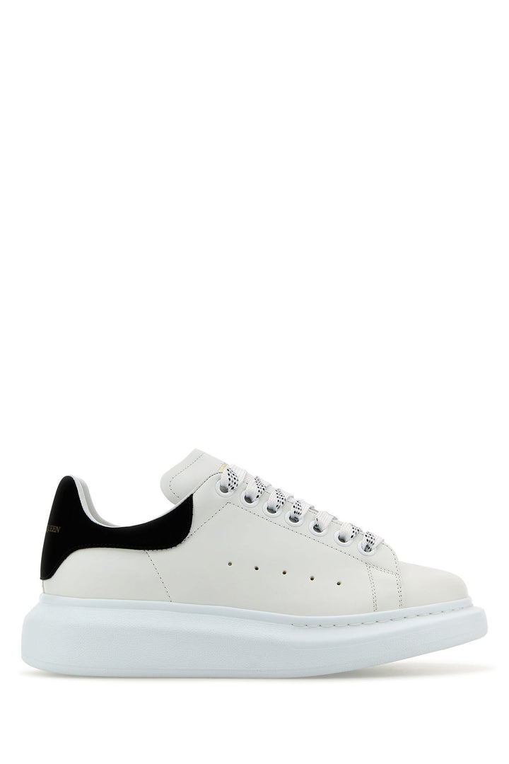 White leather sneakers with black suede heel