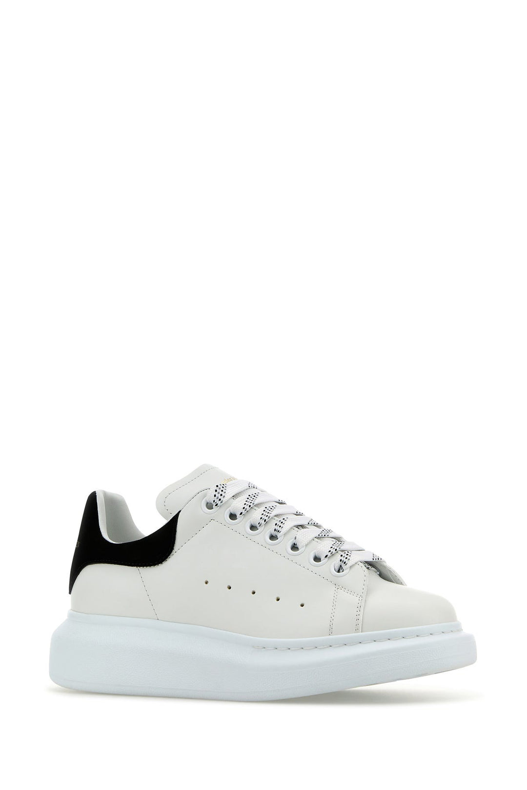 White leather sneakers with black suede heel