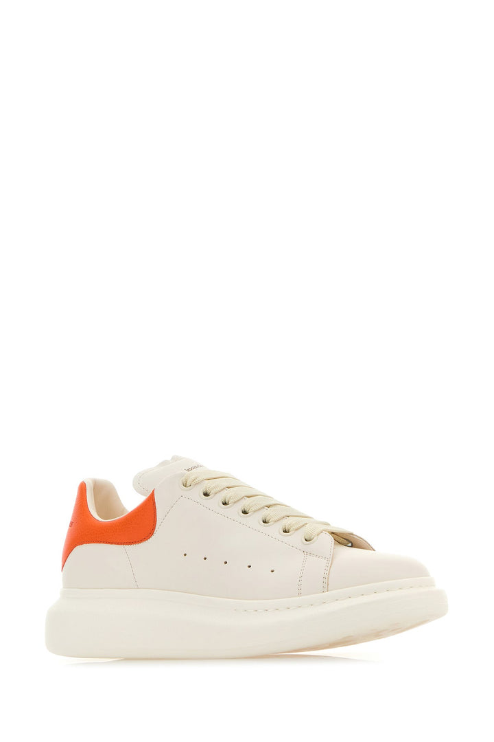 White leather sneakers with orange leather heel